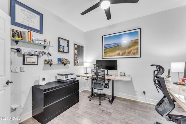 home office featuring light hardwood / wood-style flooring and ceiling fan