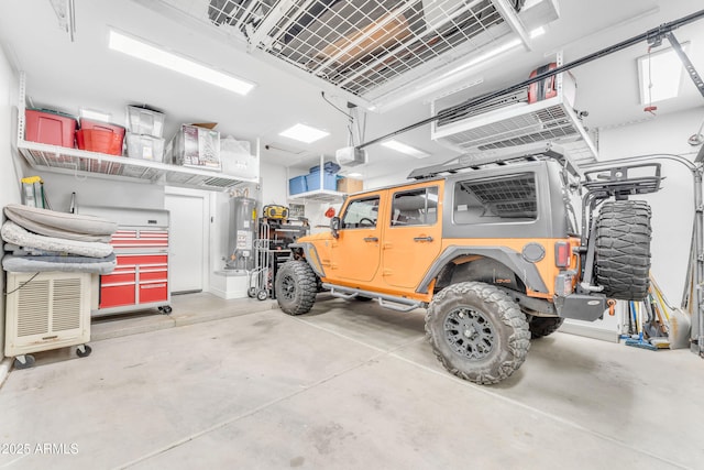 garage with water heater and a garage door opener