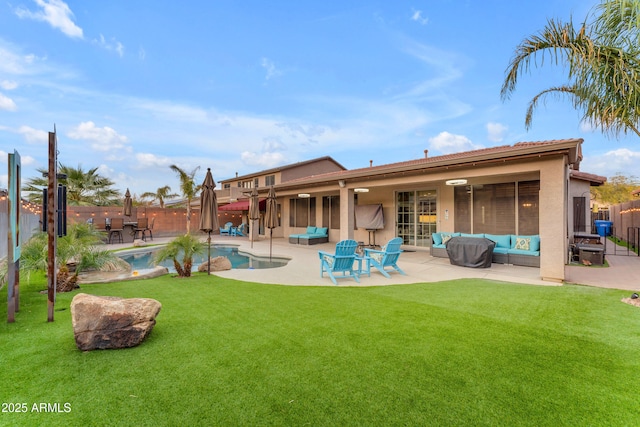 rear view of property with a fenced in pool, an outdoor hangout area, a lawn, and a patio area