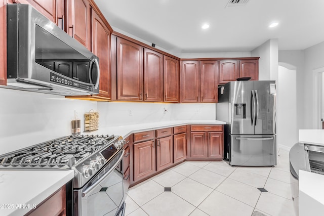 kitchen with appliances with stainless steel finishes and light tile patterned floors