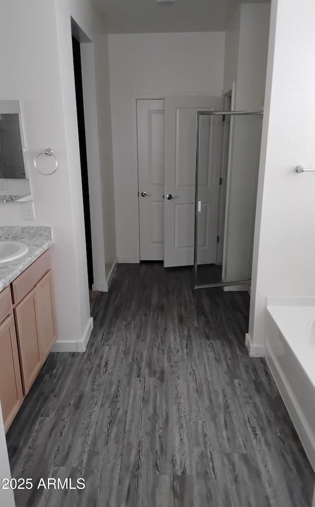 7284 E Gamebird Way, San Tan Valley, AZ 85143 - bathroom with vanity, a stall shower, wood finished floors, and a garden tub