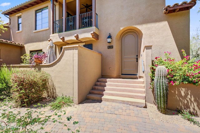 doorway to property featuring a balcony and stucco siding