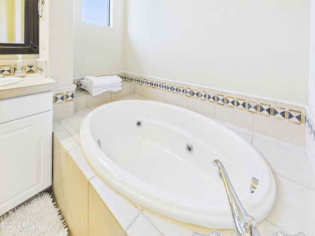 full bathroom featuring vanity and a jetted tub