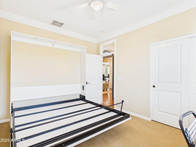 bedroom featuring crown molding, carpet flooring, baseboards, and ceiling fan