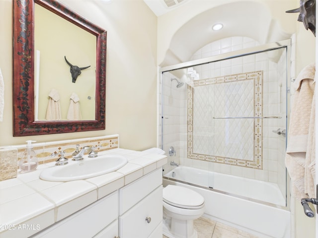 full bath featuring shower / bath combination with glass door, toilet, vanity, and tile patterned flooring