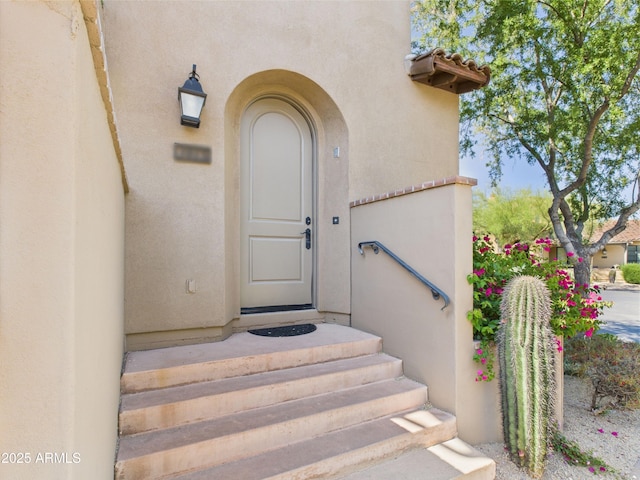 doorway to property with stucco siding