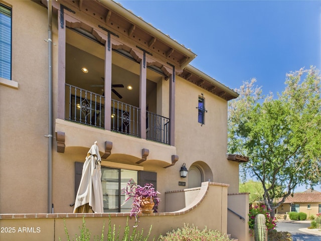 exterior space with stucco siding and a balcony