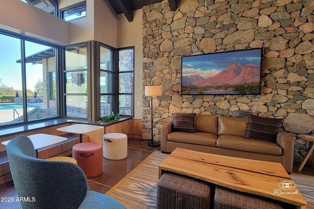 living area featuring beamed ceiling