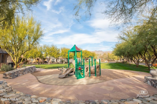 communal playground with a lawn and a mountain view