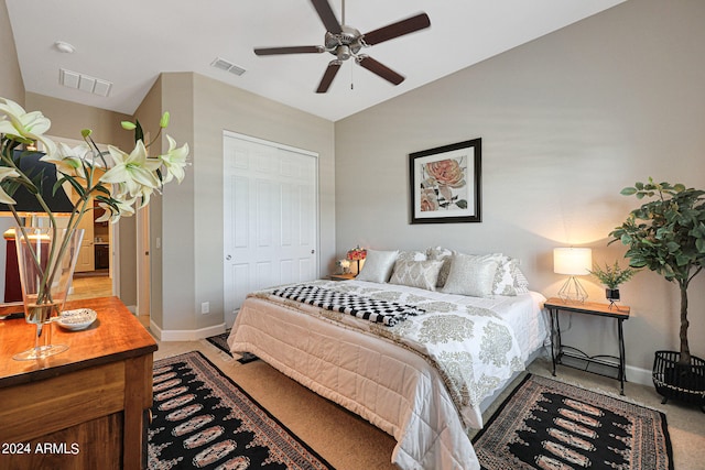 bedroom featuring light colored carpet, a closet, and ceiling fan