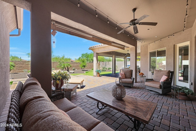 view of patio with an outdoor living space and ceiling fan