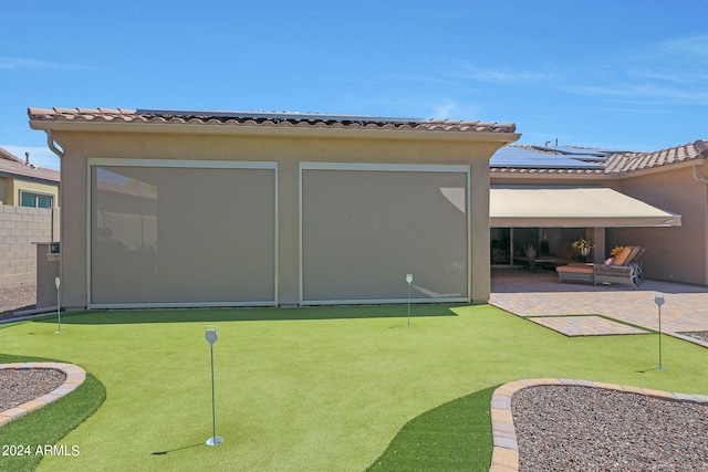 rear view of property with a patio area and an outdoor hangout area