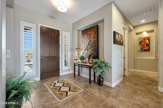 tiled foyer entrance with plenty of natural light