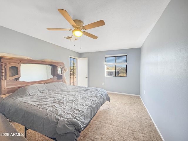 bedroom featuring carpet, a textured ceiling, and ceiling fan