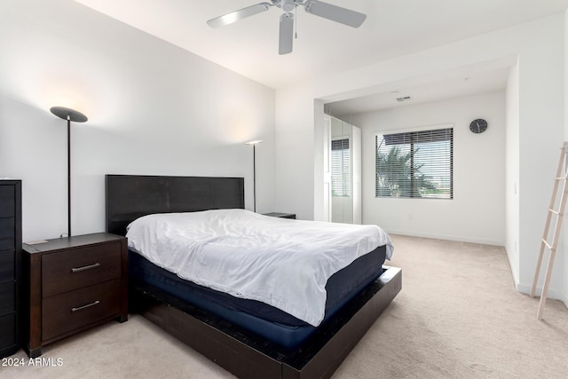 bedroom featuring light carpet and ceiling fan