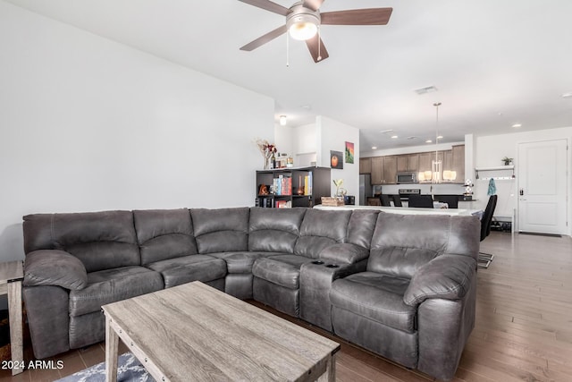 living room with dark hardwood / wood-style floors and ceiling fan