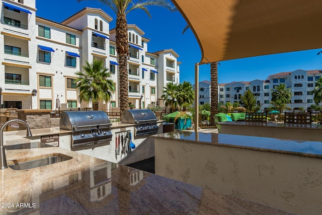 view of patio with grilling area, sink, and exterior kitchen