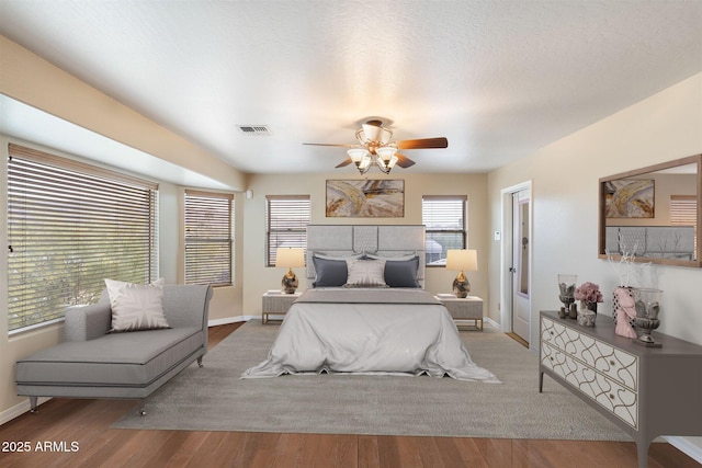19428 E Hunt Hwy, Queen Creek, AZ 85142 - bedroom with visible vents, a ceiling fan, baseboards, and wood finished floors