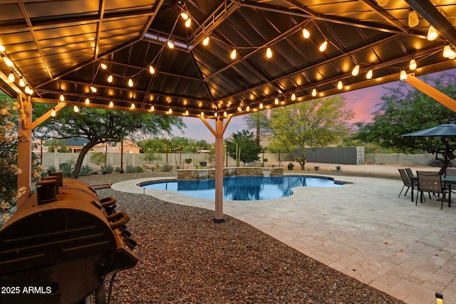 19428 E Hunt Hwy, Queen Creek, AZ 85142 - pool at dusk featuring a fenced in pool, a fenced backyard, a gazebo, and a patio