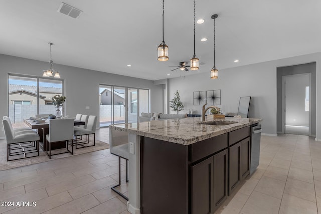 kitchen featuring dishwasher, ceiling fan with notable chandelier, hanging light fixtures, sink, and light stone countertops