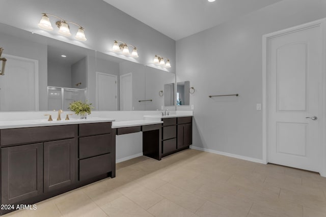 bathroom featuring tile patterned flooring, vanity, and walk in shower