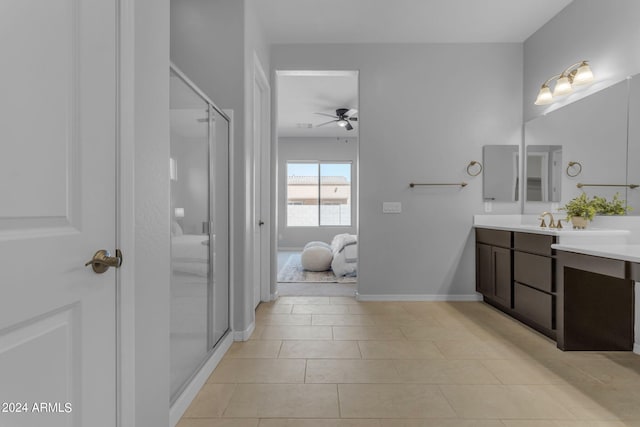 bathroom with tile patterned floors, ceiling fan, walk in shower, and vanity