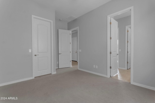 unfurnished bedroom featuring light colored carpet