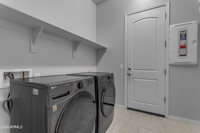 laundry area featuring light tile patterned floors and separate washer and dryer