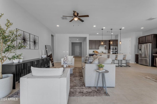 tiled living room with ceiling fan