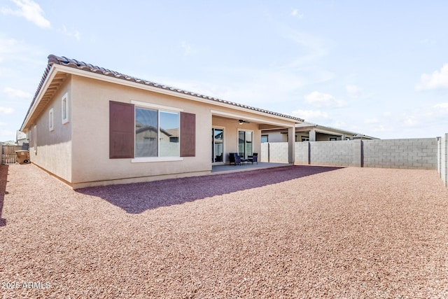 back of house featuring ceiling fan and a patio area