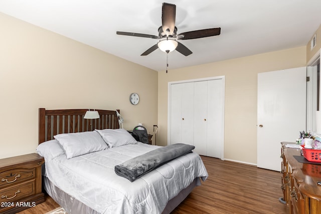 bedroom with dark hardwood / wood-style flooring, a closet, and ceiling fan