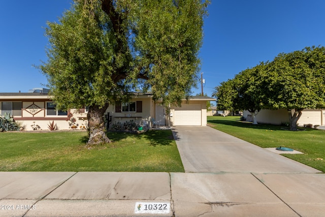 view of front of home with a garage and a front yard