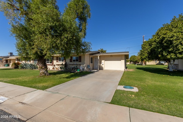 ranch-style home with a front lawn and a garage