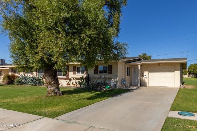 view of front of house with a front lawn and a garage