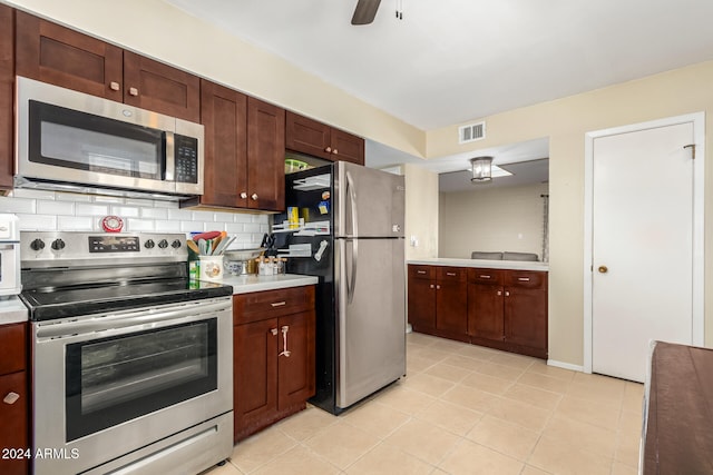 kitchen with decorative backsplash, light tile patterned flooring, stainless steel appliances, and ceiling fan