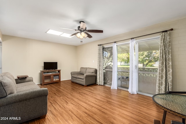 living room with ceiling fan and light hardwood / wood-style floors