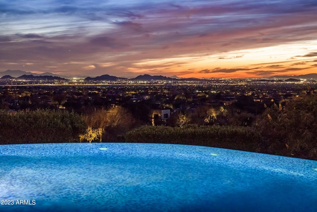 view of pool at dusk