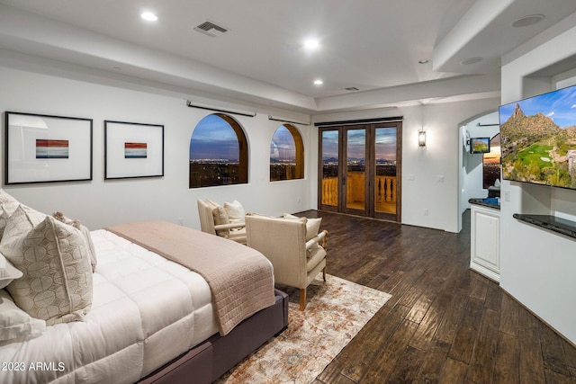 bedroom with access to exterior and dark wood-type flooring