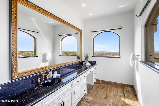 bathroom with vanity and parquet floors