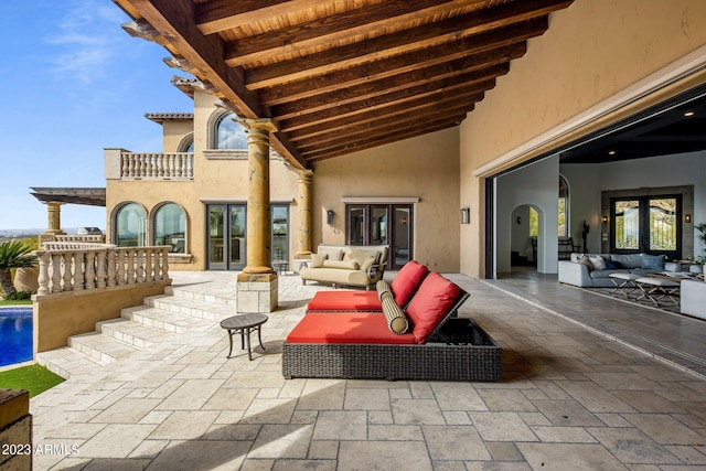 view of patio featuring outdoor lounge area and a balcony