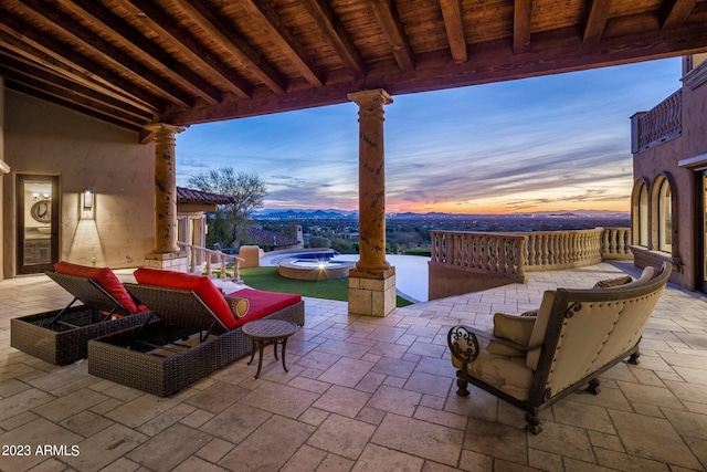 patio terrace at dusk featuring an outdoor hangout area