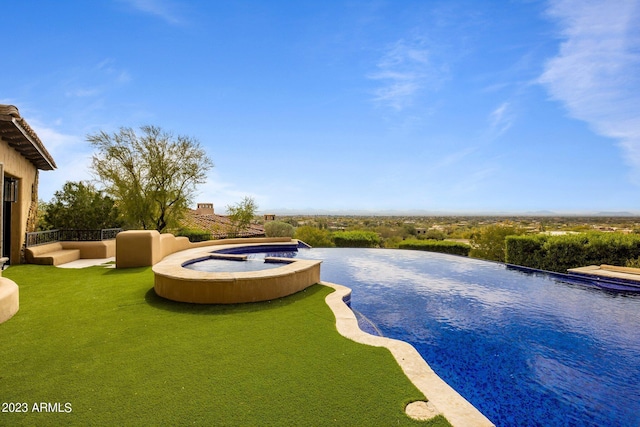 view of pool with an in ground hot tub and a lawn