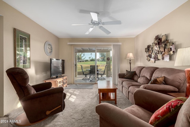 carpeted living room with ceiling fan