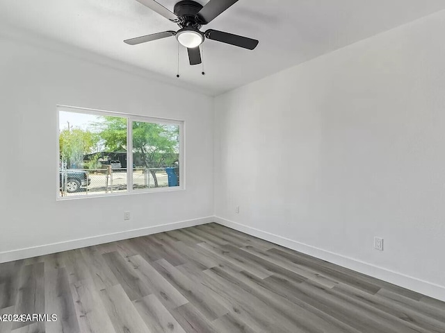 spare room with ceiling fan and hardwood / wood-style flooring