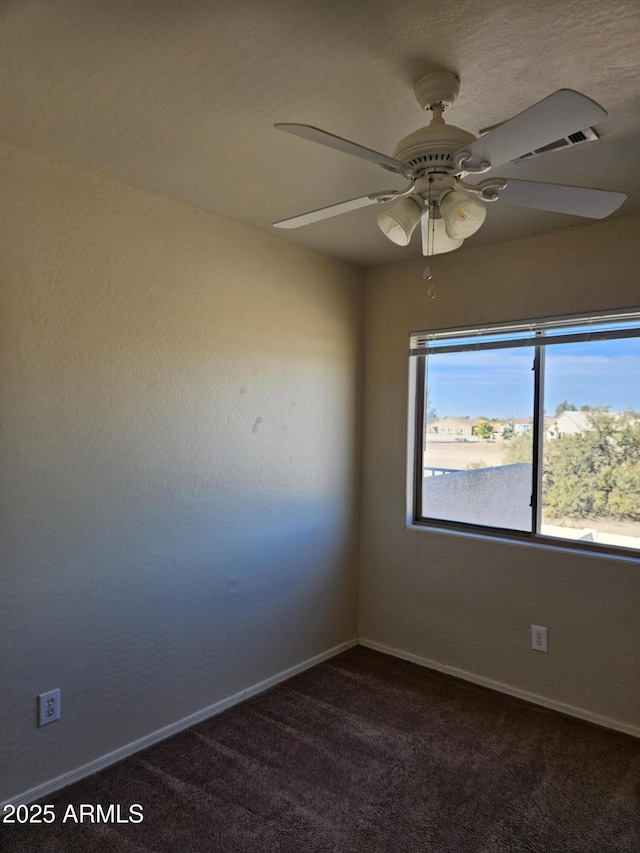 unfurnished room featuring baseboards, carpet floors, and a ceiling fan