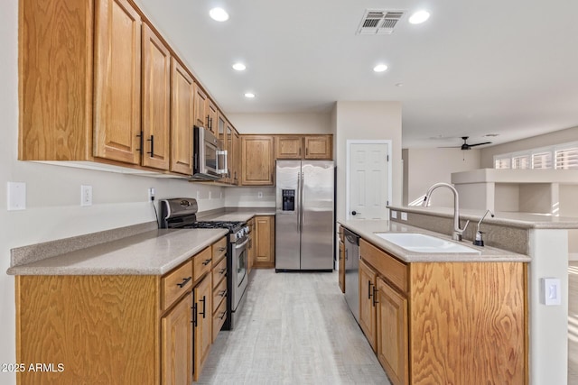 kitchen featuring recessed lighting, a sink, visible vents, appliances with stainless steel finishes, and an island with sink