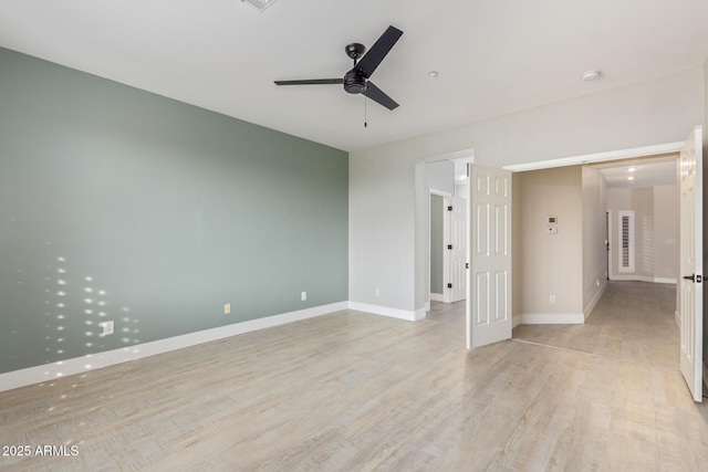 unfurnished room with light wood-style floors, baseboards, and a ceiling fan