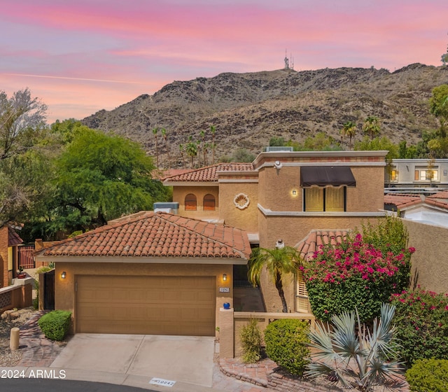 view of front of home featuring a garage and a mountain view