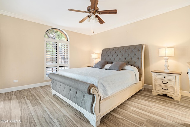 bedroom with crown molding, light hardwood / wood-style floors, and ceiling fan