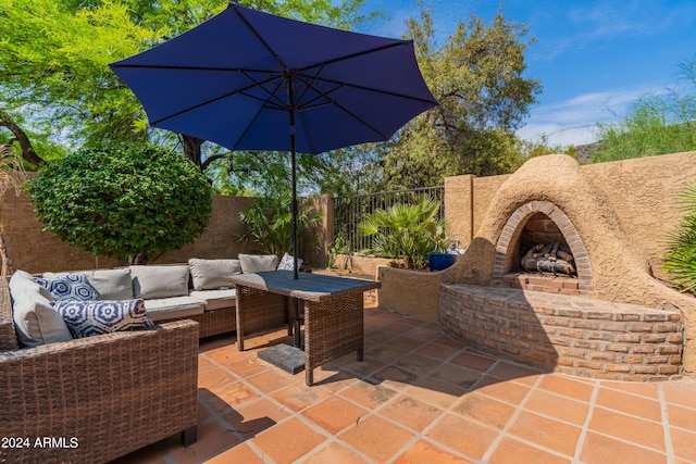 view of patio / terrace with an outdoor living space with a fireplace